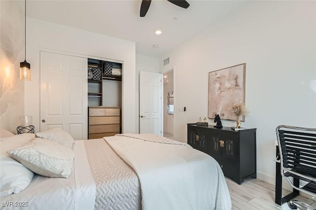 bedroom featuring ceiling fan, a closet, and light wood-type flooring