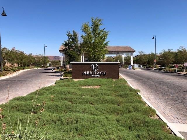 community / neighborhood sign with a yard