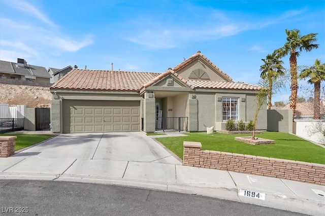 view of front of house featuring a garage and a front lawn