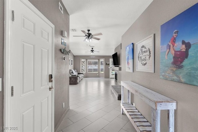 foyer entrance with ceiling fan