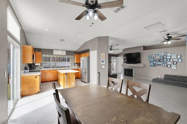 dining space featuring lofted ceiling and sink