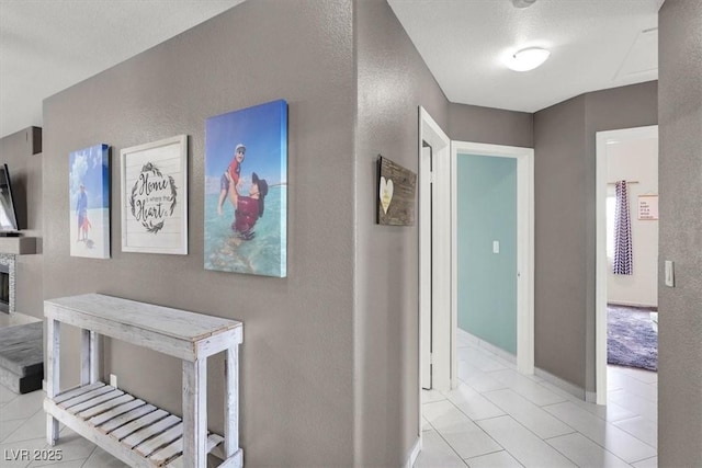 hall featuring light tile patterned flooring