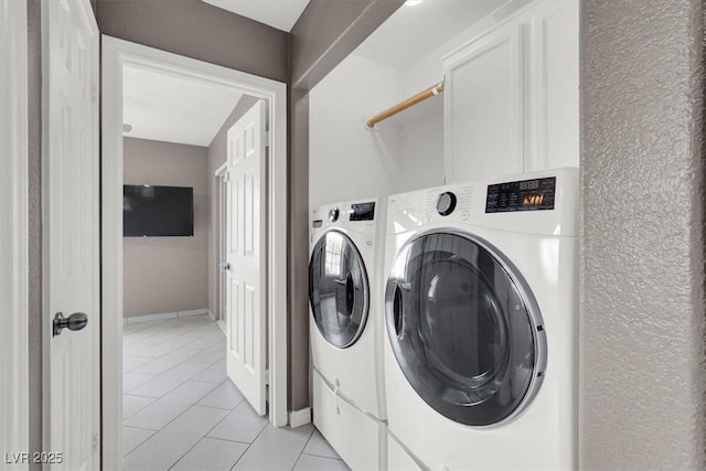 washroom with washing machine and dryer and light tile patterned floors