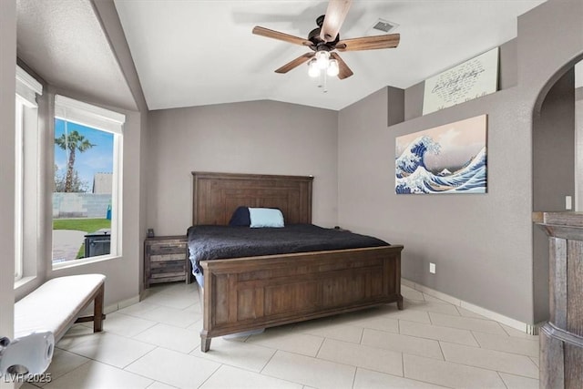 bedroom featuring ceiling fan, lofted ceiling, and light tile patterned floors