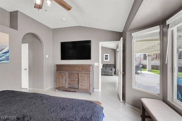 bedroom featuring lofted ceiling, light tile patterned floors, and ceiling fan