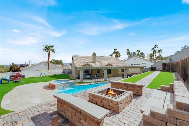 view of swimming pool featuring an outdoor fire pit, a patio, and an in ground hot tub