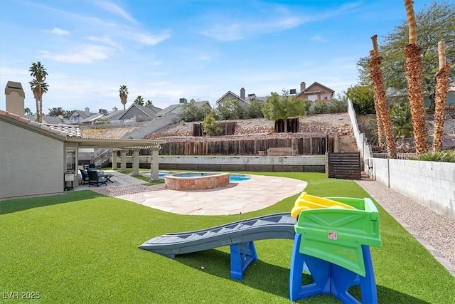 view of yard featuring an in ground hot tub and a patio area