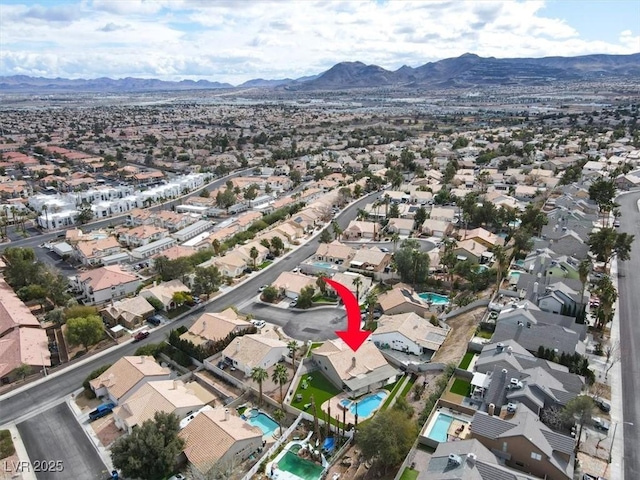 birds eye view of property with a mountain view