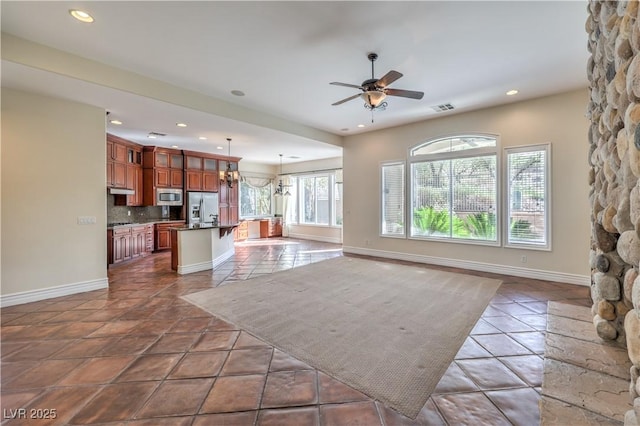 1477 Foothills Village Dr, Henderson, NV 89012 - living room featuring dark tile patterned flooring and ceiling fan with notable chandelier