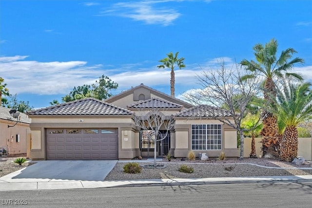 mediterranean / spanish-style house with a garage