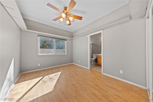 unfurnished bedroom with connected bathroom, light hardwood / wood-style flooring, and ceiling fan