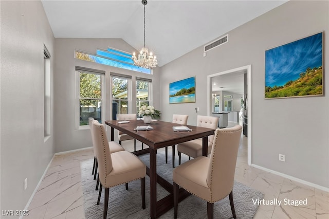 dining area with an inviting chandelier and vaulted ceiling