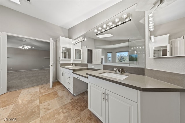 bathroom featuring vanity, vaulted ceiling, and ceiling fan