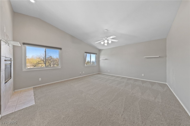 carpeted spare room with high vaulted ceiling and ceiling fan