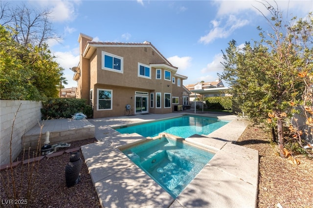 view of swimming pool with a patio area and an in ground hot tub