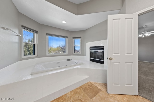 bathroom featuring a relaxing tiled tub