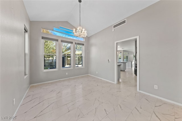 spare room featuring lofted ceiling and a notable chandelier