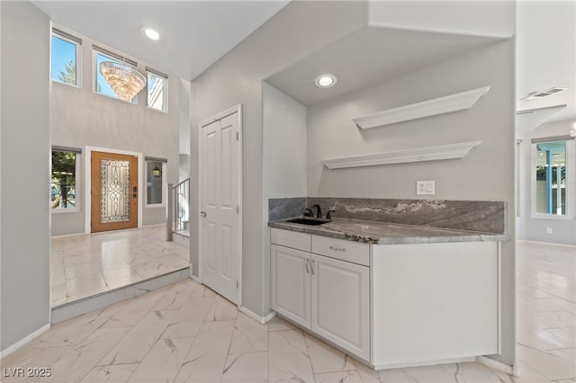 kitchen featuring sink and white cabinets