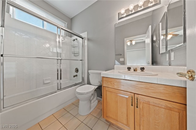 full bathroom featuring toilet, vanity, shower / bath combination with glass door, and tile patterned flooring