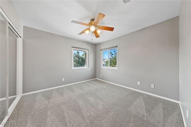 unfurnished bedroom with ceiling fan, a closet, and carpet