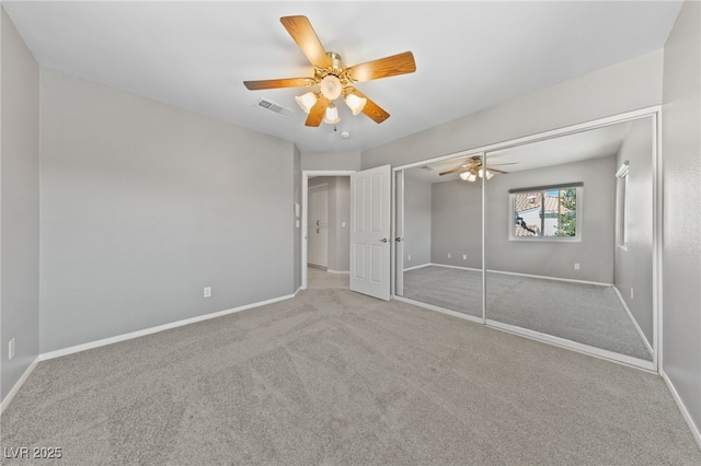 unfurnished bedroom featuring light colored carpet and ceiling fan