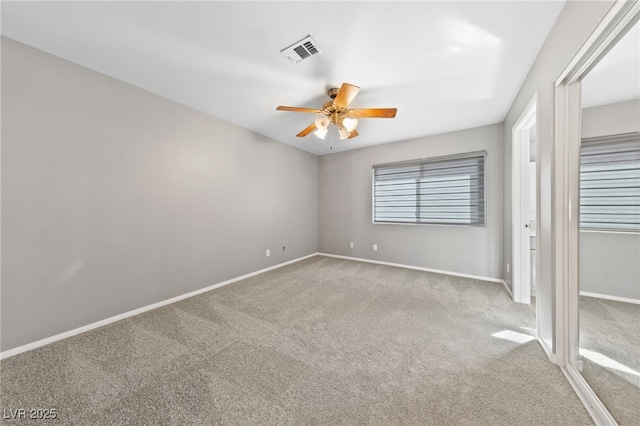 unfurnished bedroom with ceiling fan and light colored carpet