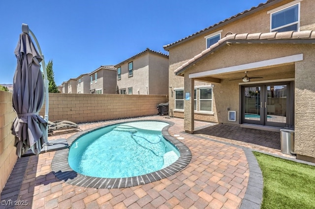 view of swimming pool featuring french doors, ceiling fan, and a patio