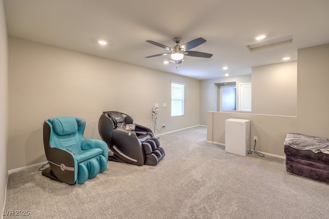 sitting room with ceiling fan and carpet flooring