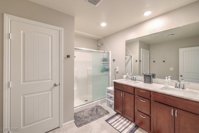 bathroom featuring vanity, a shower with shower door, and tile patterned floors