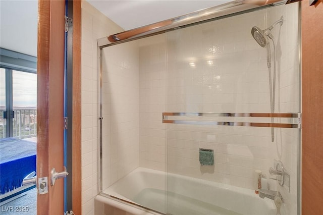 bathroom with shower / bath combination with glass door