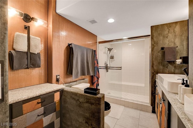 bathroom with tile patterned floors, vanity, toilet, and a shower with door