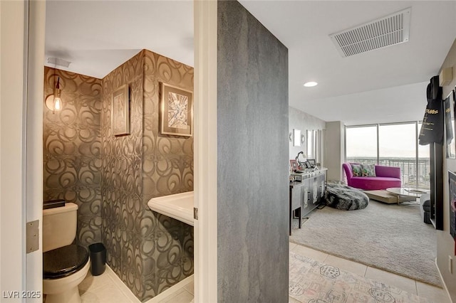 bathroom featuring tile patterned floors and toilet