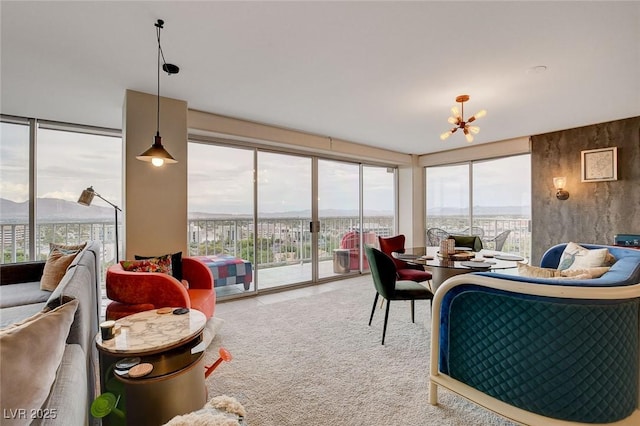 carpeted living room with an inviting chandelier