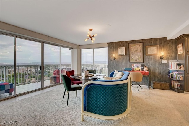 carpeted living room featuring a notable chandelier