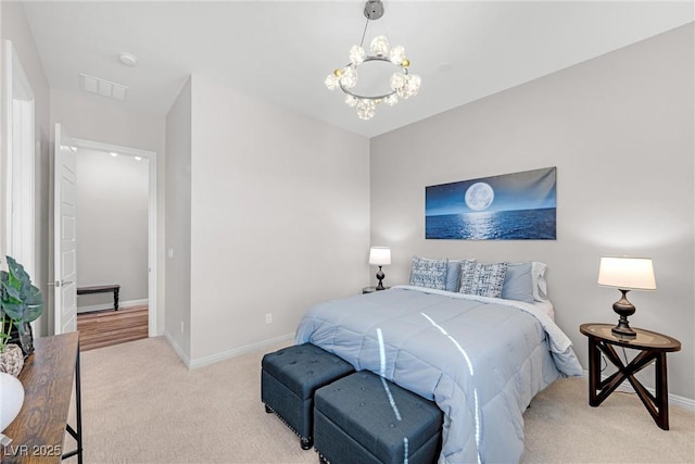 carpeted bedroom with a notable chandelier