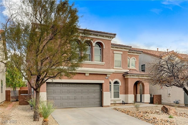 view of front of property with stucco siding, concrete driveway, fence, a garage, and a tiled roof