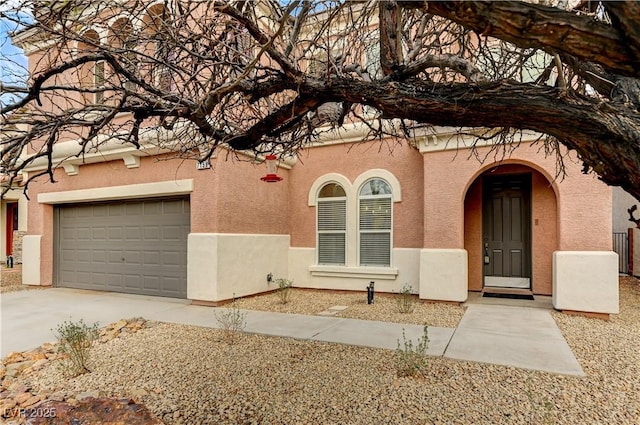 mediterranean / spanish-style home with driveway and stucco siding