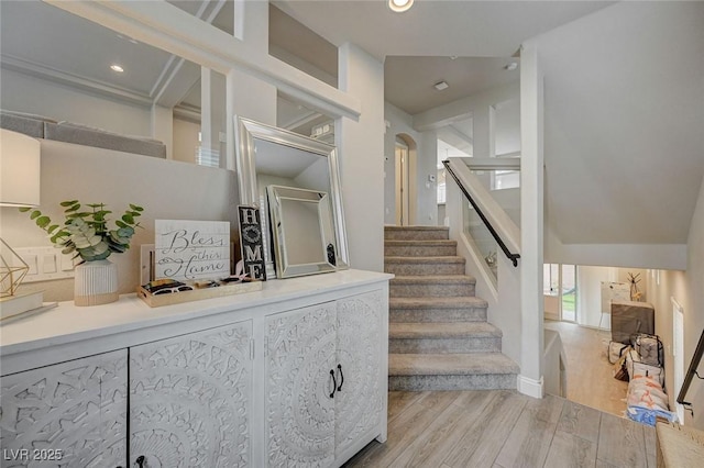 stairway featuring recessed lighting and wood finished floors