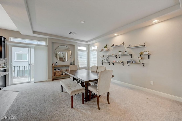 dining space featuring visible vents, a tray ceiling, recessed lighting, baseboards, and light colored carpet