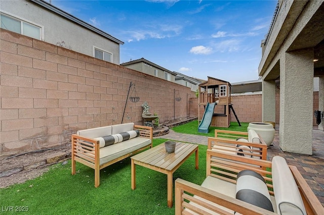 view of patio / terrace with outdoor lounge area, a playground, and a fenced backyard