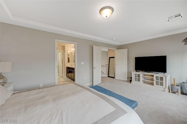 bedroom with light carpet, visible vents, connected bathroom, and baseboards