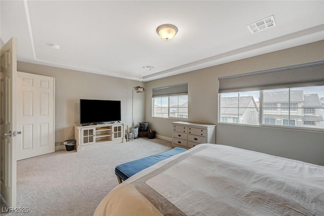 carpeted bedroom featuring visible vents and baseboards