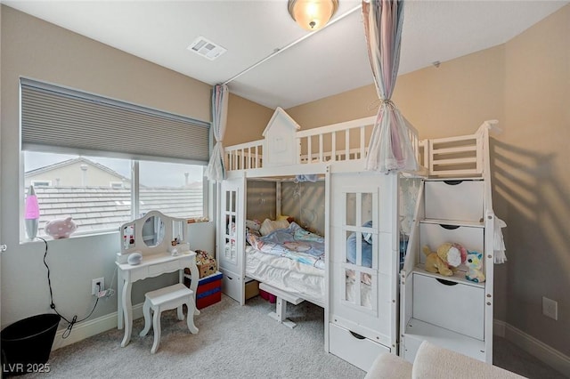 carpeted bedroom with visible vents and baseboards