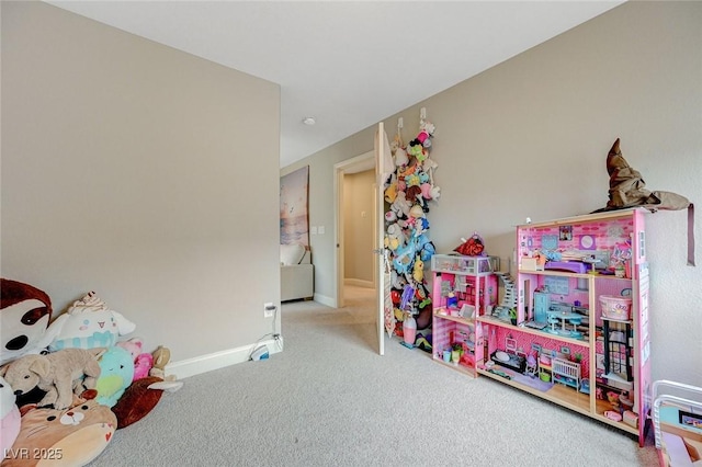 recreation room with baseboards and carpet flooring