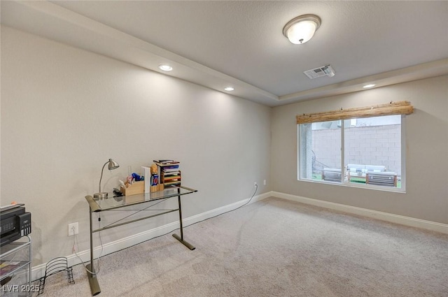 office area featuring carpet flooring, visible vents, and baseboards