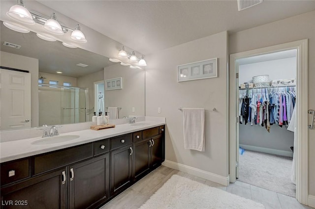 full bath with a stall shower, visible vents, and a sink