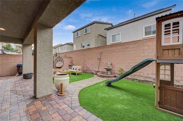 view of patio with grilling area and a fenced backyard