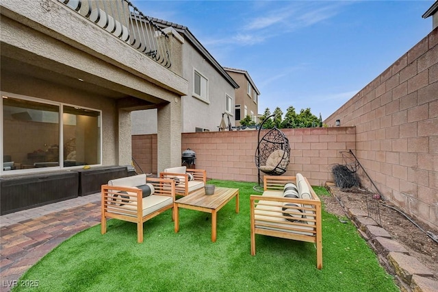 view of patio / terrace featuring an outdoor living space and a fenced backyard