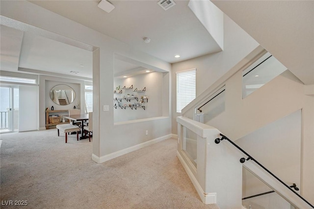 hall featuring recessed lighting, light colored carpet, visible vents, and baseboards