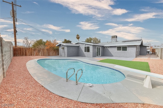 view of pool featuring a fenced backyard, central AC unit, a fenced in pool, and a patio